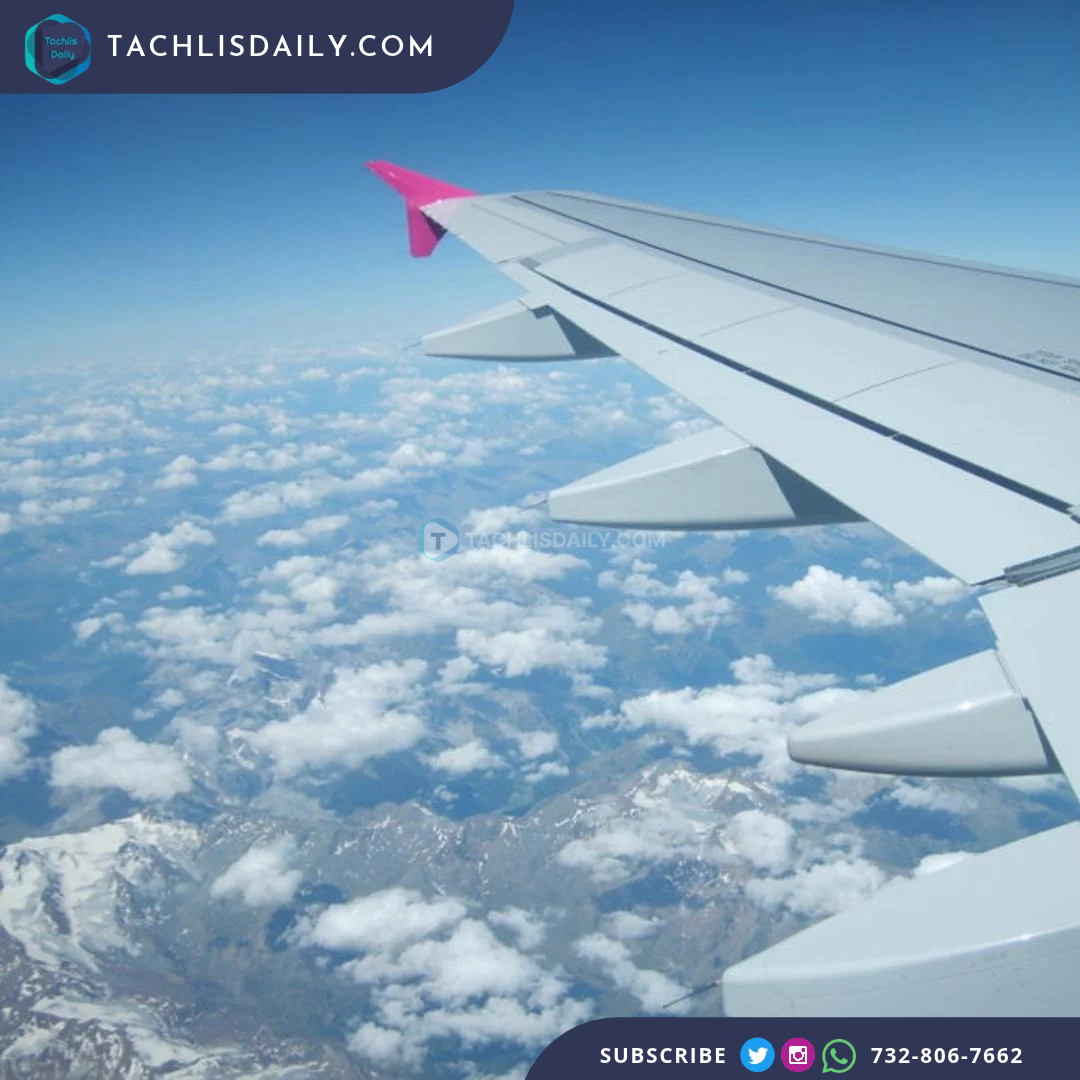 An aircraft wing above clouds.