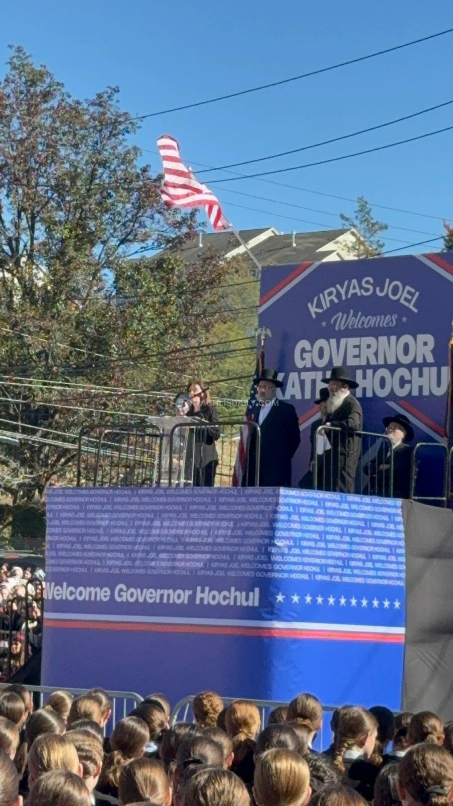 Stage with a Welcome Governor Hochul banner in Kiryas Joel